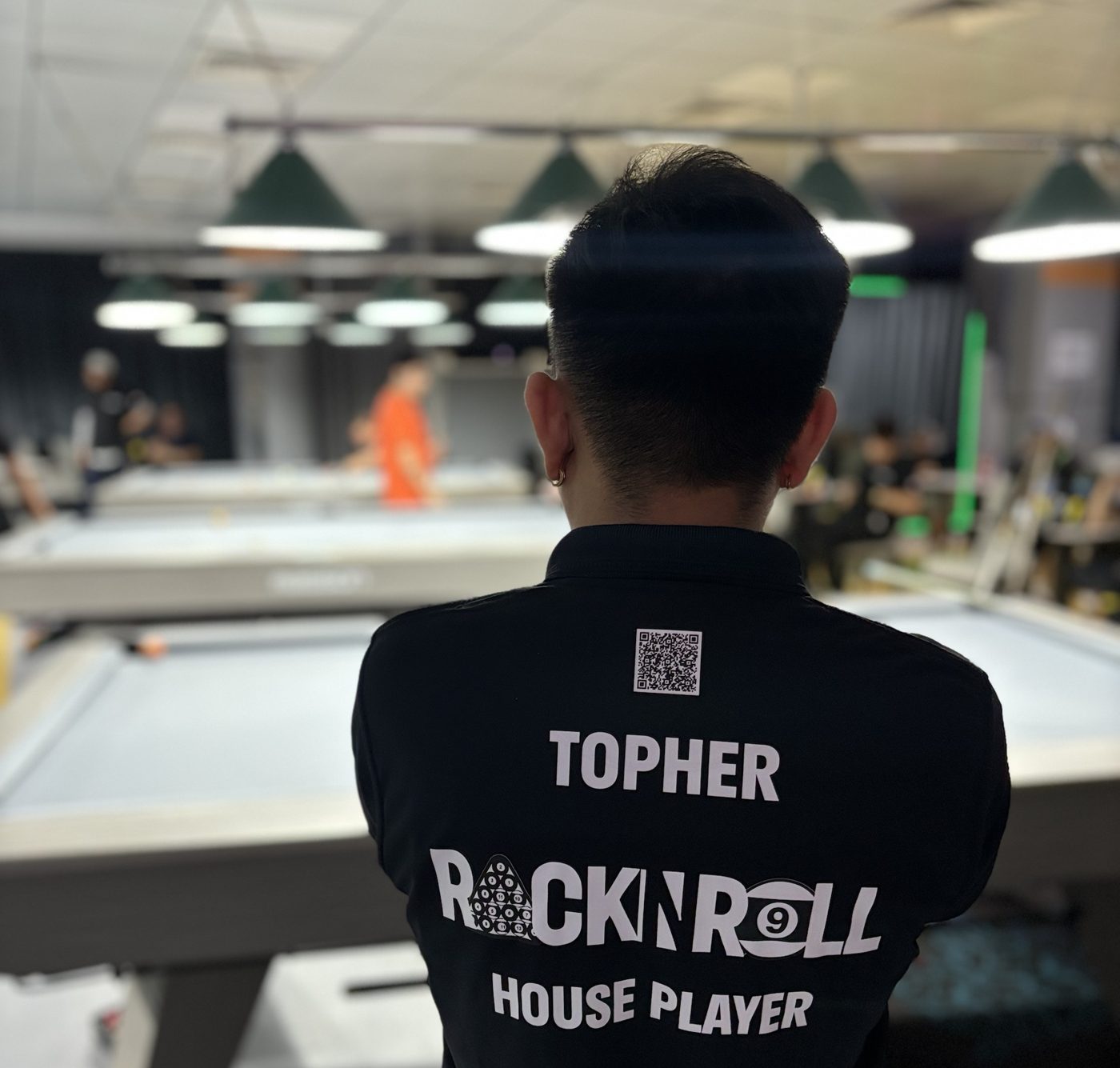 Topher, RACK N ROLL house player, watching the tables